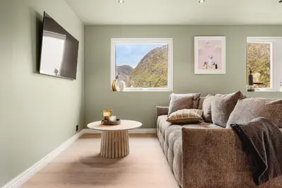 a living room with a couch and a table at Odda Living - 3BR & 1BR - A3 in Tokheim