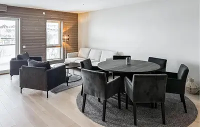 a living room with a table and chairs and a couch at Awesome Apartment In Geilo With Sauna in Geilo