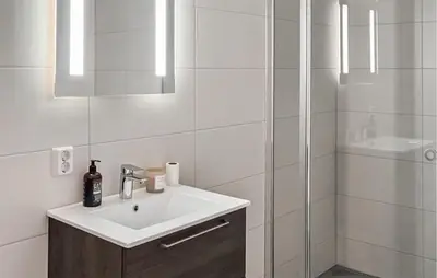 a white bathroom with a sink and a shower at Awesome Apartment In Geilo With Sauna in Geilo