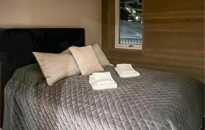 a bed with two towels on top of it at 2 Bedroom Stunning Apartment In Geilo in Geilo