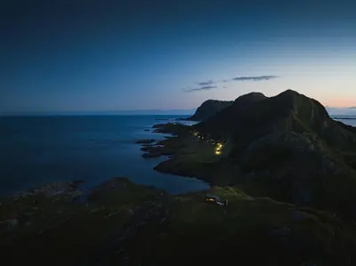 an island in the ocean at night at Birdbox Reksta in Florø