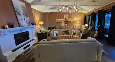 a living room with two couches and a tv at Øyer Fjellstugu in Øyer