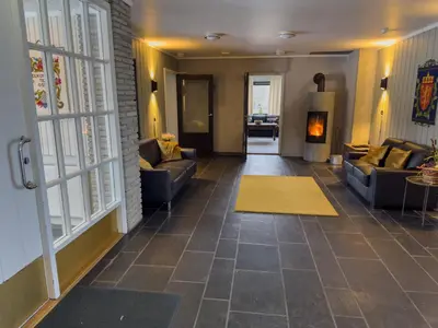 a living room with couches and a yellow rug at Øyer Fjellstugu in Øyer