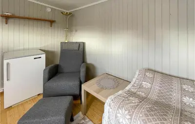 a room with a bed and a chair and a table at Awesome Home In Trysil With Wifi in Trysil
