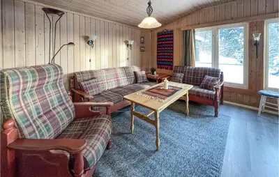 a living room with two couches and a table at Awesome Home In Trysil With Wifi in Trysil