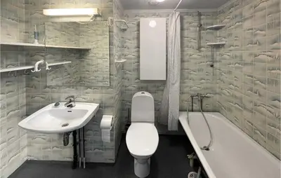 a bathroom with a sink and a toilet and a bath tub at 4 Bedroom Cozy Home In Svorkmo in Brattli