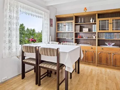 a dining room with a table and chairs and a window at 6 person holiday home in Åram-By Traum in Sandvik