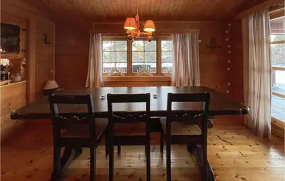 a dining room with a wooden table and chairs at 5 Bedroom Pet Friendly Home In Jordet in Jordet