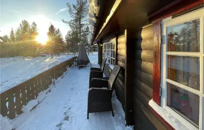 a group of chairs sitting on a porch in the snow at 5 Bedroom Pet Friendly Home In Jordet in Jordet