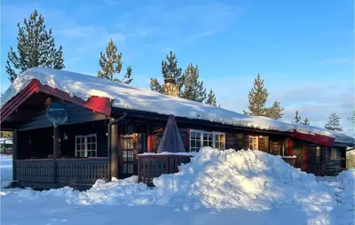 a house covered in snow with a pile of snow at 5 Bedroom Pet Friendly Home In Jordet in Jordet