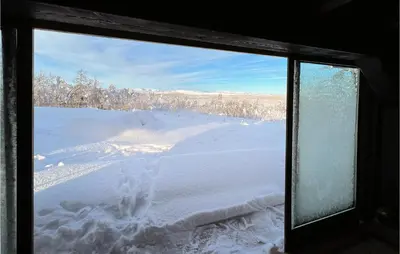 a view of a snow covered field from a window at 5 Bedroom Awesome Home In Røn in Ron