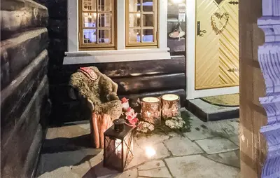 a room with two chairs and a door with lights at Awesome Home In Hemsedal With Sauna in Hemsedal
