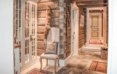 a hallway with a chair in a room with wooden walls at Awesome Home In Hemsedal With Sauna in Hemsedal
