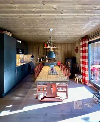 a room with a table and chairs in a kitchen at Cozy apartment ski in out, BBQ & Wifi Sjusjøen in Sjusjøen