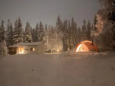a tent in the snow in front of a forest at Dome Glamping with shared bathroom in Lillehammer