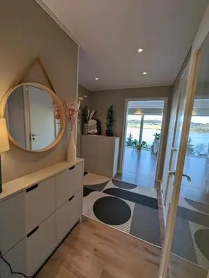 a bathroom with a mirror and a dressing room at Nyoppusset hus med utsikt. in Steinkjer