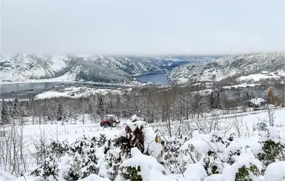a snow covered hill with a truck in the snow at 4 Bedroom Nice Home In Vang I Valdres in Vang I Valdres