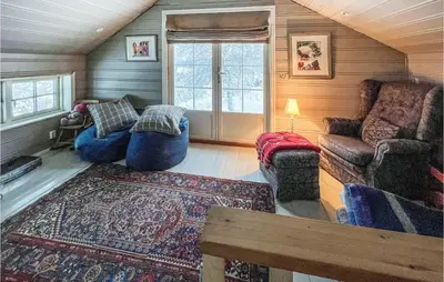 a living room with blue couches and a rug at 4 Bedroom Nice Home In Vang I Valdres in Vang I Valdres