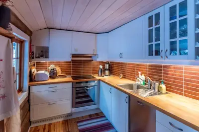 a kitchen with blue cabinets and wooden counters at Trysilfjellet sør 318 in Trysil
