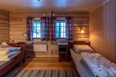 a room with two beds in a log cabin at Trysilfjellet sør 318 in Trysil