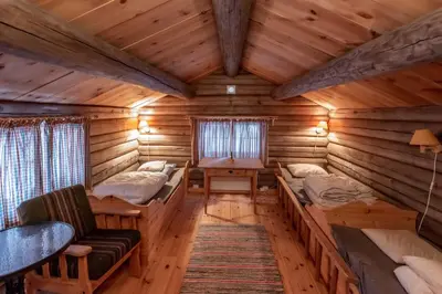 a room with two beds in a log cabin at Trysilfjellet sør 318 in Trysil