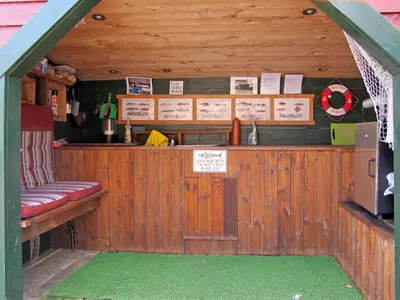 a bar with a red bench in a cabin at Holiday Home Kalavåg by Interhome in Kalavåg