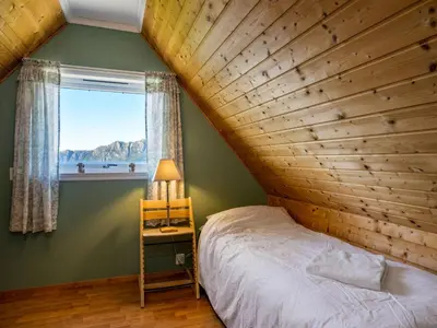 a bedroom with a bed and a window at Chalet Seievika by Interhome in Brekke