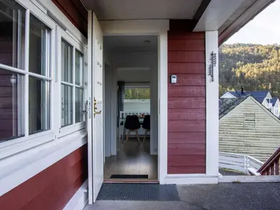 an open door of a house with a table outside at Chalet Heggland Huset by Interhome in Heggland