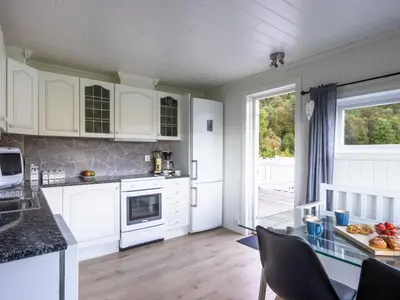 a kitchen with white cabinets and a glass counter top at Chalet Heggland Huset by Interhome in Heggland