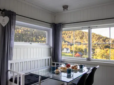 a dining room with a table and a window at Chalet Heggland Huset by Interhome in Heggland