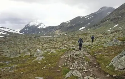 two people walking on a trail in the mountains at Bassebuupdalstøl in Tyinkrysset