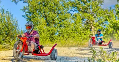 two people riding on four wheelers on a dirt road at Active Adventure Base - Apartment & Lavvo, Dagali Fjellpark in Dagali