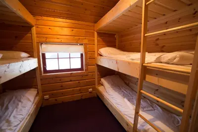 a bedroom with bunk beds in a log cabin at Active Adventure Base - Apartment & Lavvo, Dagali Fjellpark in Dagali