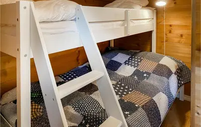 two bunk beds in a room with a bed at 4 Bedroom Awesome Home In Nordfjordeid in Nordfjordeid