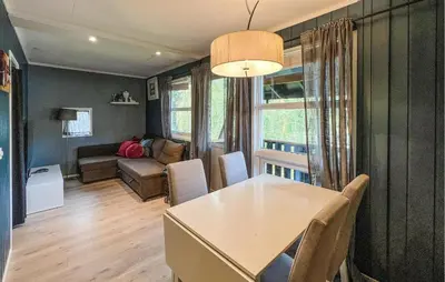 a living room with a table and a couch at 1 Bedroom Amazing Apartment In Øyer in Øyer