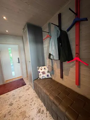 a room with a couch and a wall with a door at Villa Blue Dream in Kristiansund