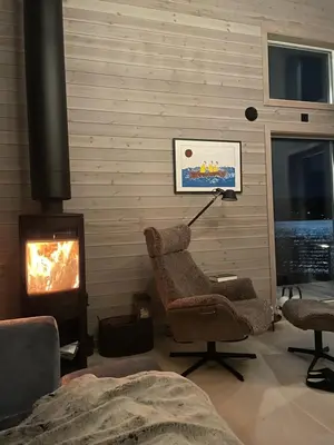 a living room with a chair and a fireplace at Villa Blue Dream in Kristiansund