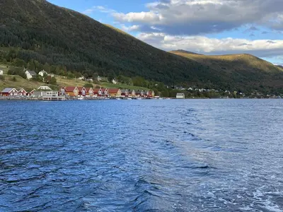 a large body of water with houses and a mountain at 6 person holiday home in Gursken-By Traum in Larsnes