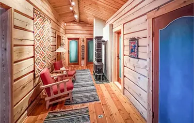 a living room with wood paneling and a fireplace at Stunning Home In Kvam With Wifi in Kvam