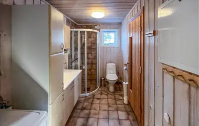a bathroom with a toilet and a sink and a shower at Stunning Home In Sjusjøen With Sauna in Sjusjøen