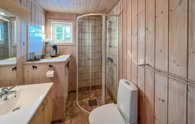a bathroom with a shower and a toilet and a sink at Stunning Home In Sjusjøen With Sauna in Sjusjøen