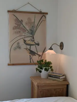 a bedroom with a table with a lamp and a plant at Bellahuset - Charming House in Ulsteinvik in Ulsteinvik
