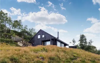 a black house on top of a hill at Beautiful Home In Jøsenfjorden in Gullingen