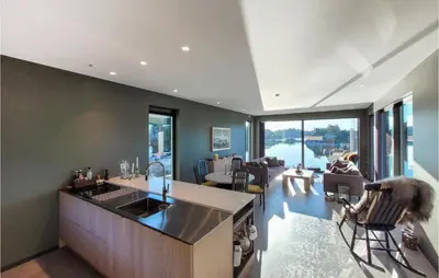 a kitchen and living room with a view of the water at 5 Bedroom Lovely Home In Urangsvåg in Ervik