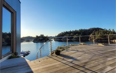 a wooden deck with a view of a body of water at 5 Bedroom Lovely Home In Urangsvåg in Ervik