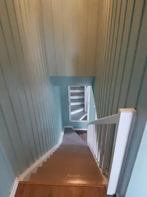 a stairway in a room with a blue wall at Comfortable zone in Hønefoss