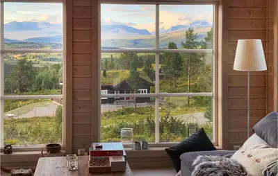 a living room with a large window with a view of mountains at Awesome Home In Kvam With Sauna in Kvam