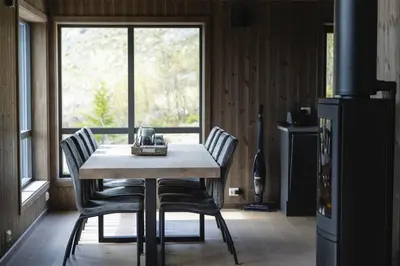 a table and chairs in a kitchen with a window at Chill cabin - fantastic view and nice hiking area in Aurdal