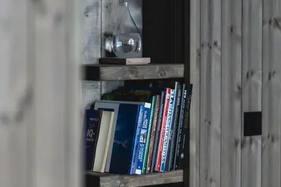 a wooden book shelf with books on it at Chill cabin - fantastic view and nice hiking area in Aurdal