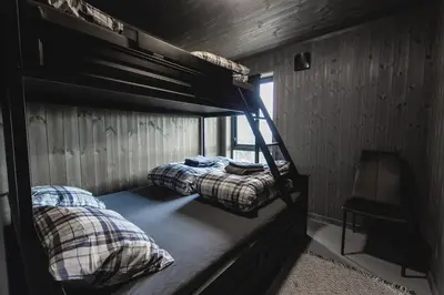 two bunk beds in a room with a window at Chill cabin - fantastic view and nice hiking area in Aurdal